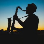 silhouette of a man playing saxophone during sunset